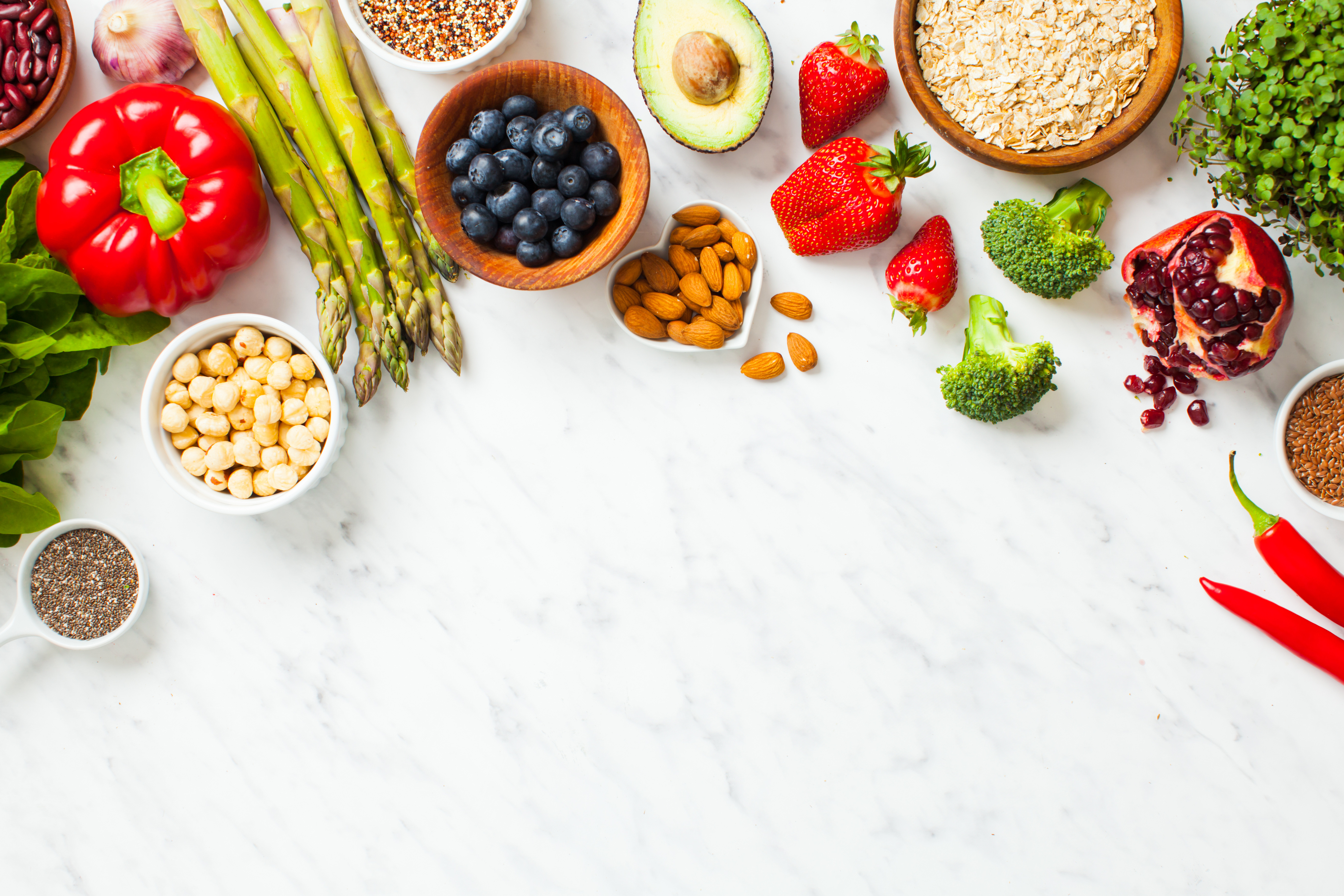 Assorted Fresh Healthy Foods on White Marble Table